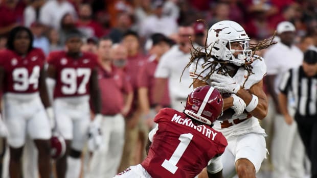 Texas Longhorns wide receiver Jordan Whittington (13) makes a reception in front of Alabama Crimson Tide defensive back Kool-Aid McKinstry (1) at Bryant-Denny Stadium.